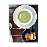 a bowl of soup and bread on a table