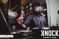 a man with a beard and glasses is working on a computer