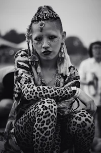 a woman in a leopard print outfit sits on a bench