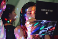 a group of people at a party looking at a disco light