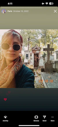 a woman is taking a selfie in front of a graveyard